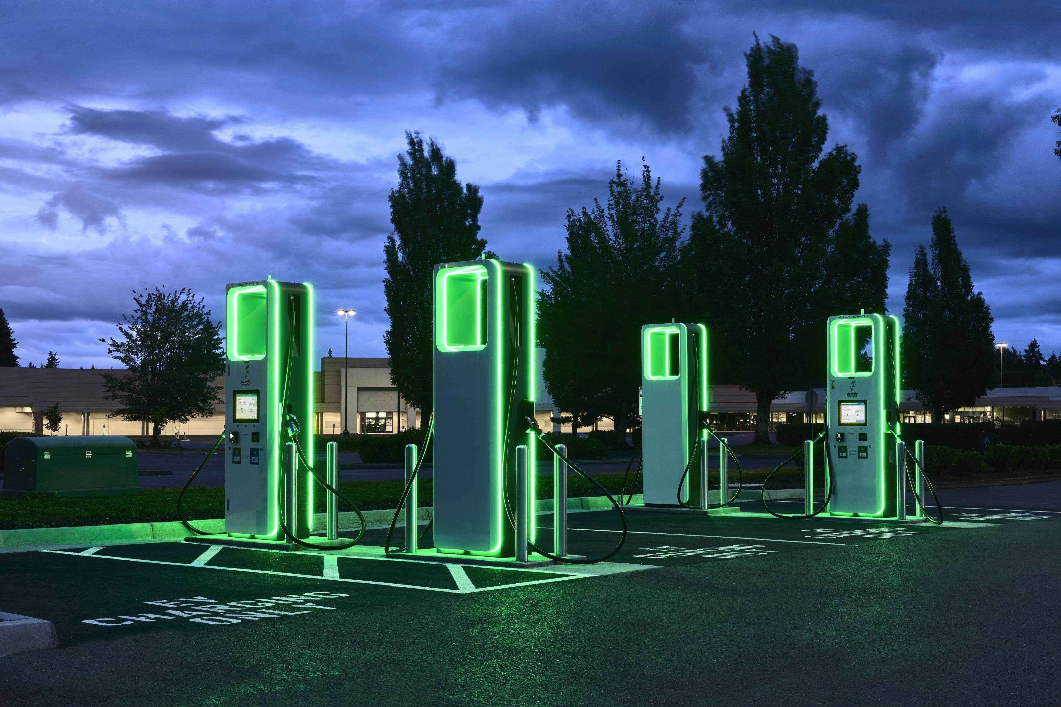 electrify america chargers glowing green at night